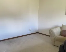 Living room space empty after removal of unwanted piano.