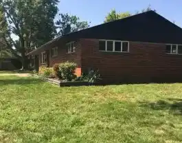 residential yard reclaimed of big brush pile after professional yard waste disposal services